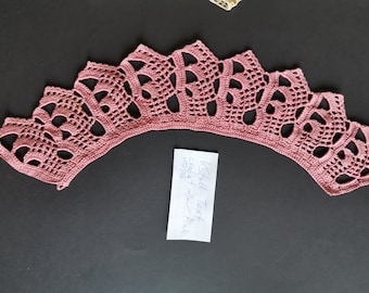 May include: A pink crocheted lace collar with a scalloped edge. The collar is made with a delicate pattern of flowers and leaves. The text on the note reads "Small Text Collar + 1 collar = Price $20.96"