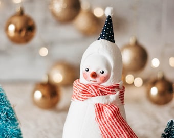 Plush snowman figurine with a red scarf - whimsical winter decoration