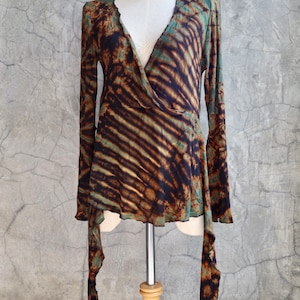 May include: A long-sleeved, brown and green tie-dye wrap top with a V-neckline and a flowing, asymmetrical hem.