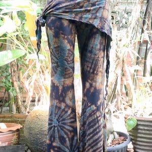 May include: A pair of brown and blue tie-dye bell bottom pants with a matching tie-dye wrap skirt.