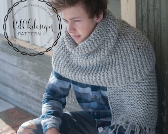 May include: A young person wearing a gray knitted scarf with fringe, a blue plaid shirt, and ripped jeans. The scarf is wrapped around the neck and hangs down the front of the body. The person is sitting on a wooden floor with snow on the ground.