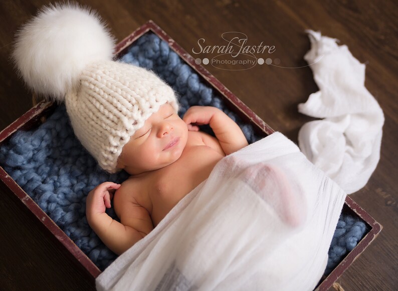white knitted baby hat