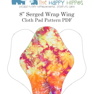 Puede incluir: Un patrón para una compresa de tela con alas envolventes serigrafiadas de 8 pulgadas. El patrón está impreso sobre un fondo blanco con un diseño de teñido anudado colorido. El texto "The Happy HIPPOS because every hippopotamus deserves cloth" está impreso en la parte superior del patrón.