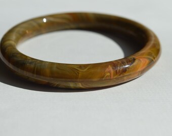 May include: A brown and orange agate bangle bracelet with a polished finish.