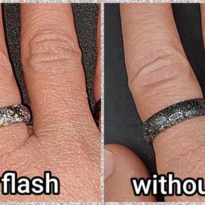 May include: Two images side-by-side show a ring with and without flash. The ring appears silver with glitter when the flash is on. Without the flash, the ring appears dark gray with glitter. The text "with flash" and "without flash" are below the images.