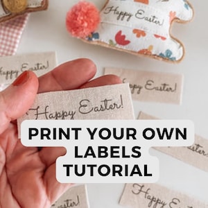 May include: Image of Easter crafts and labels. A hand holds a label with "Happy Easter!" written on it. The image also shows a tutorial title "Print Your Own Labels". Bunny-shaped decorations with floral patterns are also visible.
