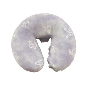 May include: A lavender-colored, U-shaped neck pillow with a white butterfly pattern. The pillow is made of soft, plush fabric.