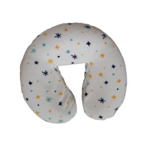 May include: White neck pillow with a blue, green, and yellow star pattern.