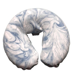 May include: A blue and white marbled fabric neck pillow for massage therapy.