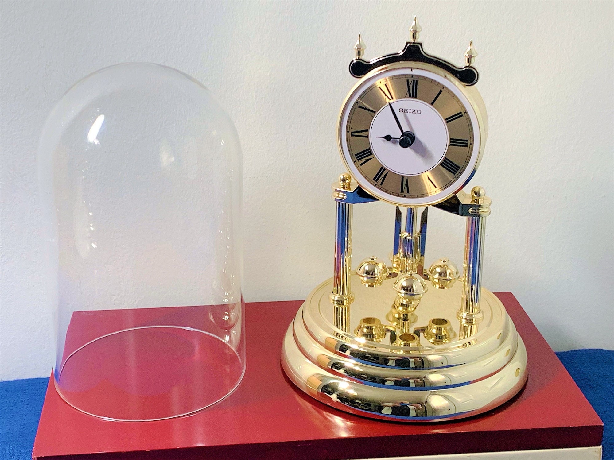 Seiko QHN006G Anniversary Clock with Rotating Pendulum Gold 