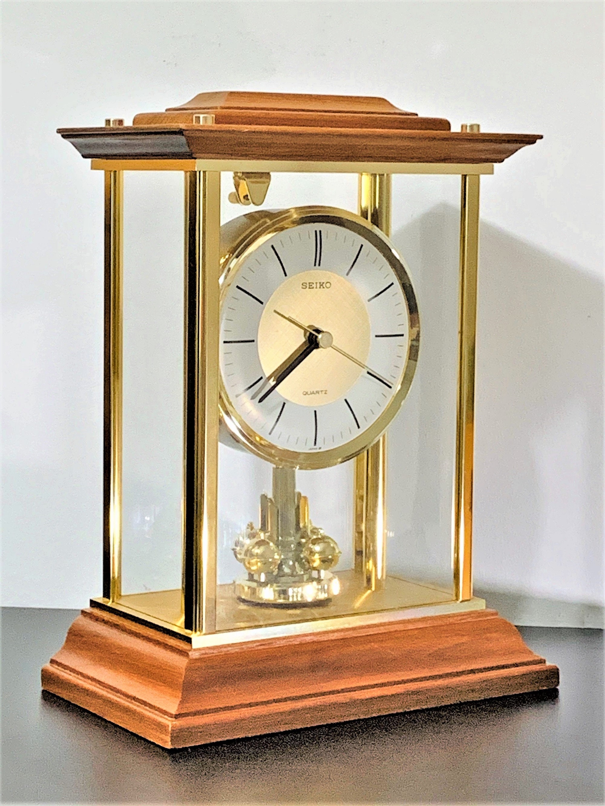 Seiko Limited Solid Cherry Hardwood, Brass and Glass Case Rotating Pendulum  Clock, 11 H.  W. 5 L. Mint Condition, Free US Shipping.