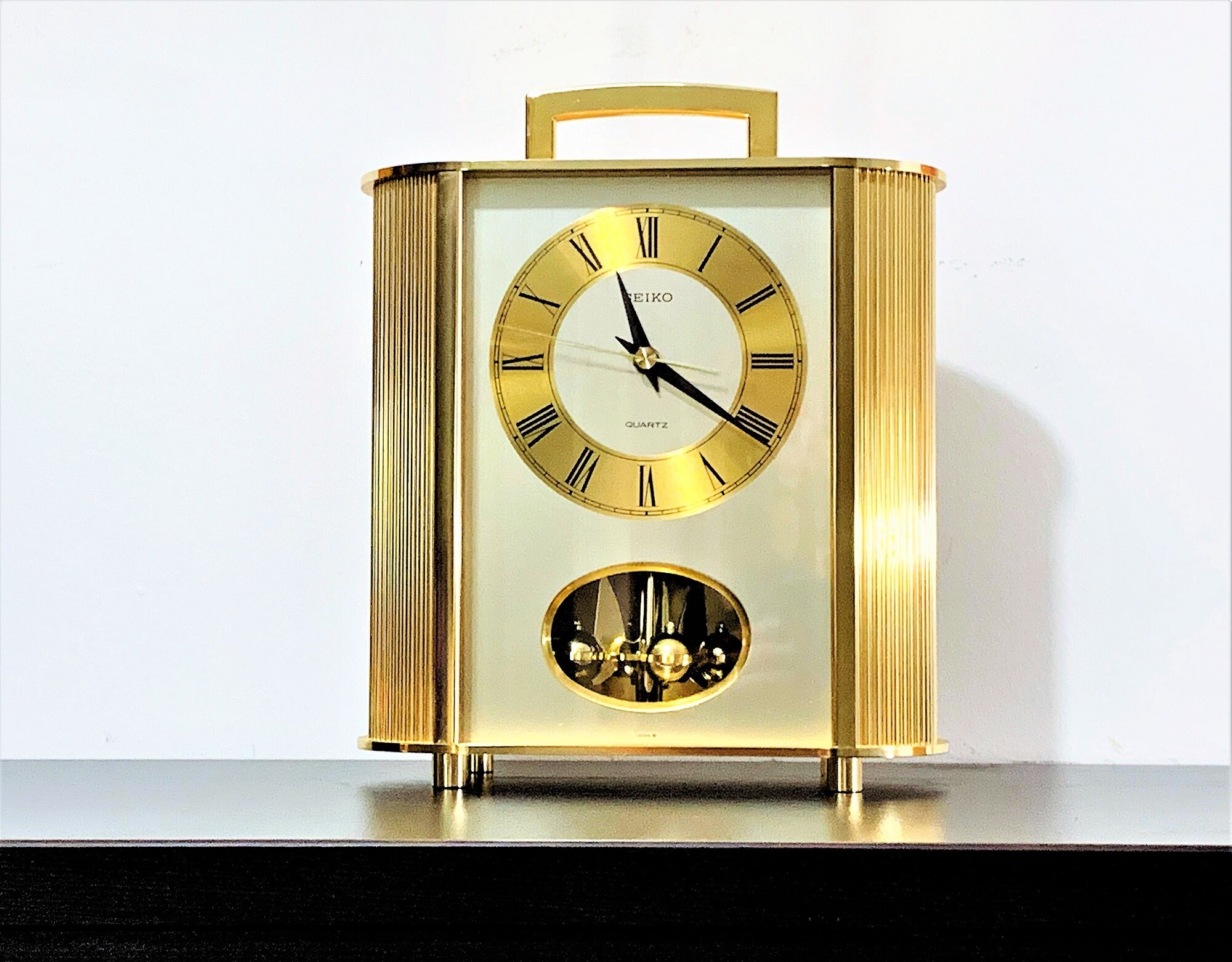 Seiko Limited Carriage Brass & Brass Finish Case Rotating Pendulum Quartz Clock, #QQ2186G. 10.5 H. 9 W. Mint Condition, Free US Shipping. Seiko Limited Carriage Brass & Brass Finish Case Rotating Pendulum Quartz Clock, #QQ2186G. 10.5 H. 9 W. Mint Condition, Free US Shipping.