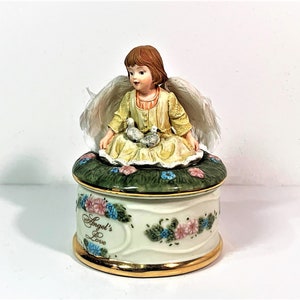 Angel’s Love by Dona Gelsinger, 1999 Heaven’s Little Guardians Music Box Collection, No. A419. Plays “Cherish”, 5” T. 3.25” Base.