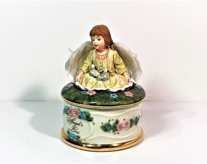 Angel’s Love by Dona Gelsinger, 1999 Heaven’s Little Guardians Music Box Collection, No. A419. Plays “Cherish”, 5” T. 3.25” Base.