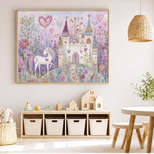 May include: A rectangular wall art print featuring a white unicorn standing in a garden with colourful flowers and trees. A large castle with multiple towers sits in the background under a sky filled with floating pink and purple heart shapes.