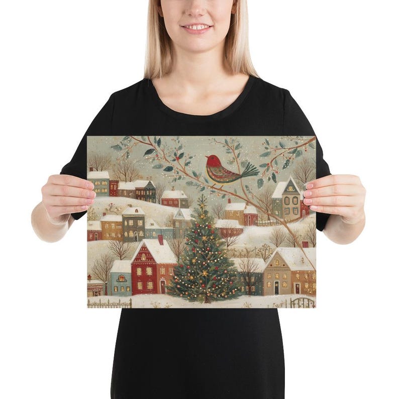 May include: A rectangular art print featuring a winter village scene with snow-covered houses, a central decorated Christmas tree, and a red bird perched on a branch. The illustration uses a muted colour palette with soft white, red, and green tones.
