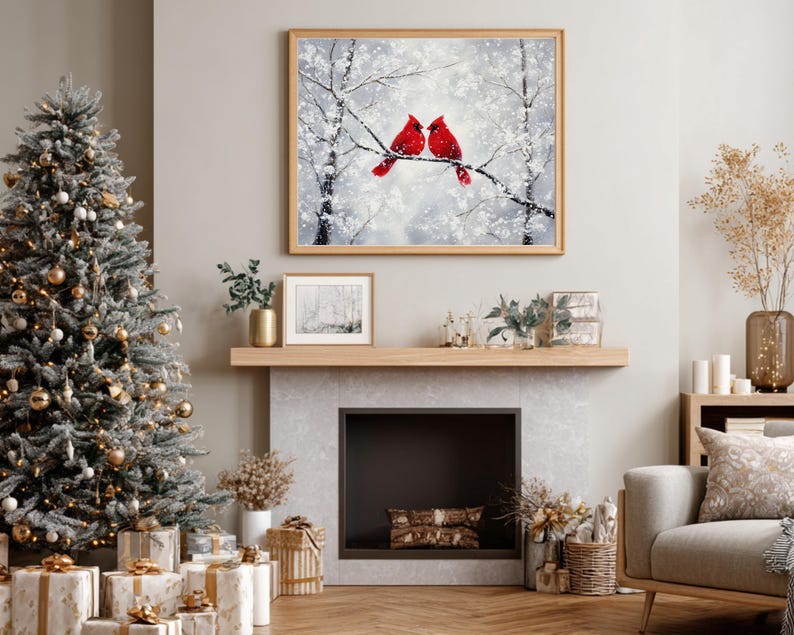 May include: A cozy living room scene with a decorated Christmas tree, wrapped gifts, and a framed painting of two red cardinals perched on a snowy branch. The room features a fireplace and neutral-toned furniture.