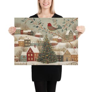May include: A rectangular art print featuring a winter village scene with snow-covered houses, a central decorated Christmas tree with lights, and a red bird perched on a branch in the upper section. The colour palette includes muted tones of grey, white, red, and green.