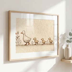 May include: Framed art print featuring a mother duck and her three ducklings walking in a line. The illustration is in soft, muted tones of beige, brown, and green, creating a gentle, nature-inspired scene. The artwork is framed in a light wood frame.