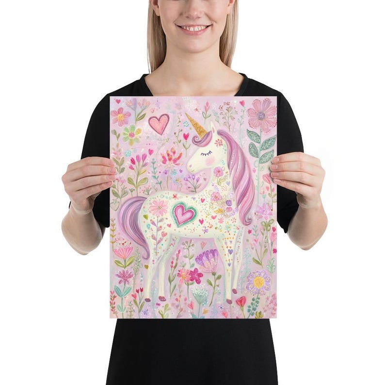 May include: A whimsical print featuring a white unicorn with a golden horn and pink mane and tail, surrounded by colorful flowers and hearts. The artwork has a soft, pastel color palette, with a light pink background. The unicorn has a heart-shaped design on its side.