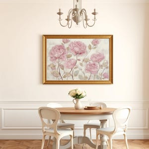 May include: A dining room scene featuring a framed floral painting with pink roses. A round wooden table is set with a vase of white flowers and tableware. White chairs surround the table, and a chandelier hangs above.