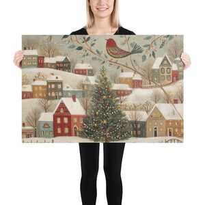 May include: A rectangular print featuring a winter village scene with snow-covered houses in shades of red, blue, and cream. A large, lit Christmas tree stands in the centre, and a red bird is perched on a branch in the upper right corner.