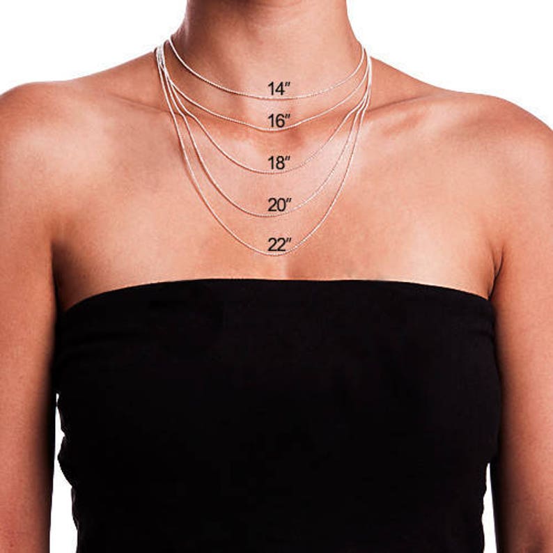 May include: A model wearing a silver chain necklace with five different lengths marked with the measurements 14", 16", 18", 20", and 22".