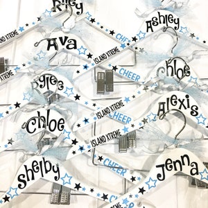Personalized uniform hanger for cheerleaders and dancers