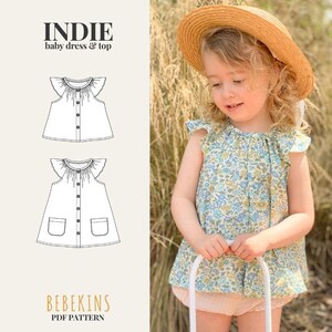 May include: A sewing pattern for the Indie baby dress and top by Bebekins, featuring a line drawing of a sleeveless top with ruffled shoulders and a button-front dress with pockets, shown alongside a floral print top with ruffled sleeves.