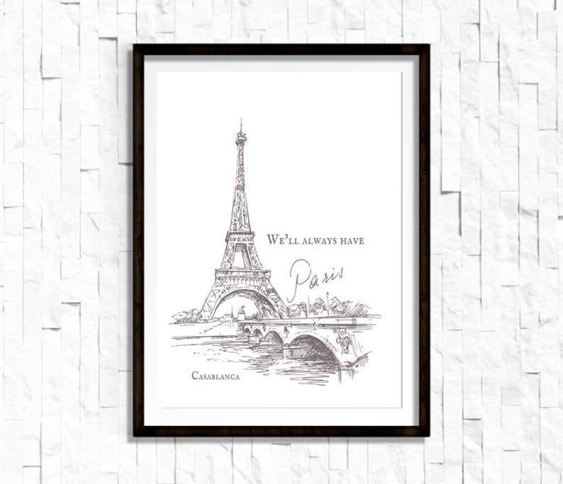 May include: A black and white line drawing of the Eiffel Tower in Paris, France. The text "We'll always have Paris" is written above the tower. The text "Casablanca" is written below the tower.