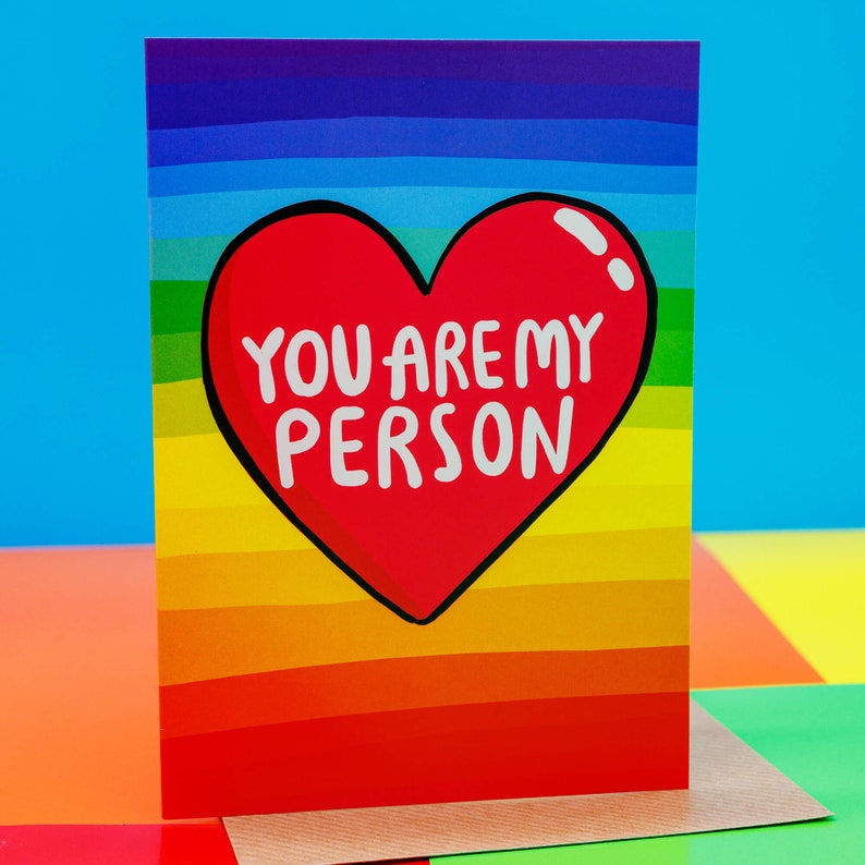 A Katie Abey A6 rainbow backed greeting card with a big red hear in the middle and the words inside You are my person