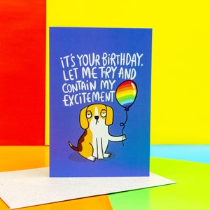 a floppy eared beagle dog on a blue A6 card holding a rainbow balloon looking very unenthusiastic with text saying its your birthday let me try to contain my excitement