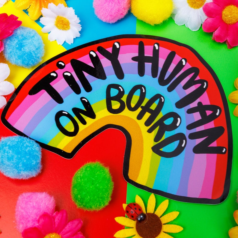 Tiny human on board vinyl car window sticker featuring black text on a rainbow design by Katie Abey laminated and weather proof