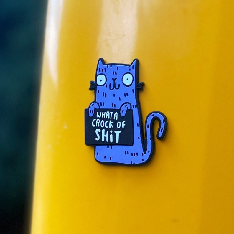 Swear Word Blue and Black Cat Fridge Magnet holding funny sign. Designed by Katie Abey in the UK