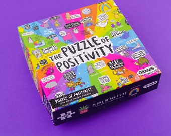 May include: A colorful jigsaw puzzle box titled "The Puzzle of Positivity." The box features a vibrant design with cartoon illustrations and motivational phrases. The puzzle contains 1000 pieces. The box is on a purple surface.