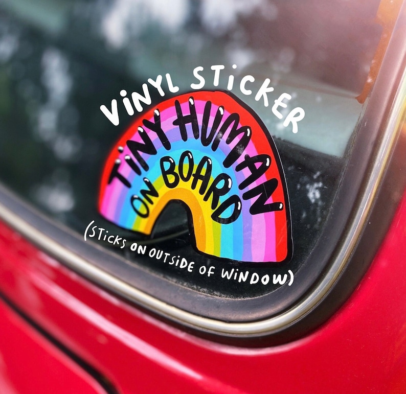 Tiny human on board vinyl car window sticker featuring black text on a rainbow design by Katie Abey laminated and weather proof