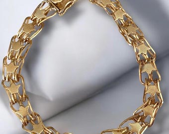May include: A gold-colored bracelet with a star-shaped link design. The bracelet is made of metal and features a clasp closure. The links are connected in a chain-like pattern, creating a stylish accessory.