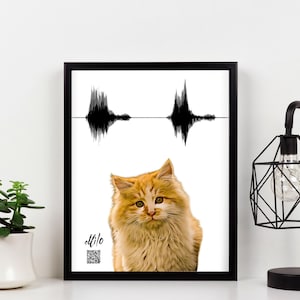 May include: A framed print featuring a portrait of a fluffy orange cat centered below a black sound wave graphic. The name Milo is written in black script above a small square QR code in the lower left corner of the white background.