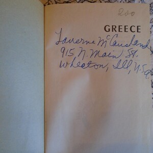 May include: A book titled "Greece" with handwritten inscription: "Laverne McLawsland 915 N. Main St. Wheaton, Ill. U.S.A."