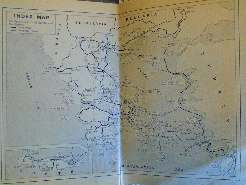 May include: A black and white map of Greece with the title "Index Map" and the text "The figures refer to the numbers of the chapters. Main Roads, Boundary Roads". The map shows the regions of Greece, including Crete, and the Aegean Sea.