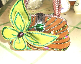 Fashion Purse, Moni Couture Butterfly and Clover Purse. Multicolored Beads Draped Across from Big Green Beaded Butterfly and Clover