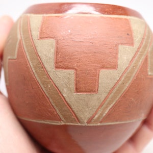 May include: A set of three ceramic vases in varying heights. The vases have a matte finish in shades of cream, beige, and brown. The tallest vase is approximately 10 inches high.