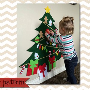 May include: A felt Christmas tree with a variety of felt ornaments, including stars, bells, candy canes, and presents. A child is decorating the tree with a felt ornament.