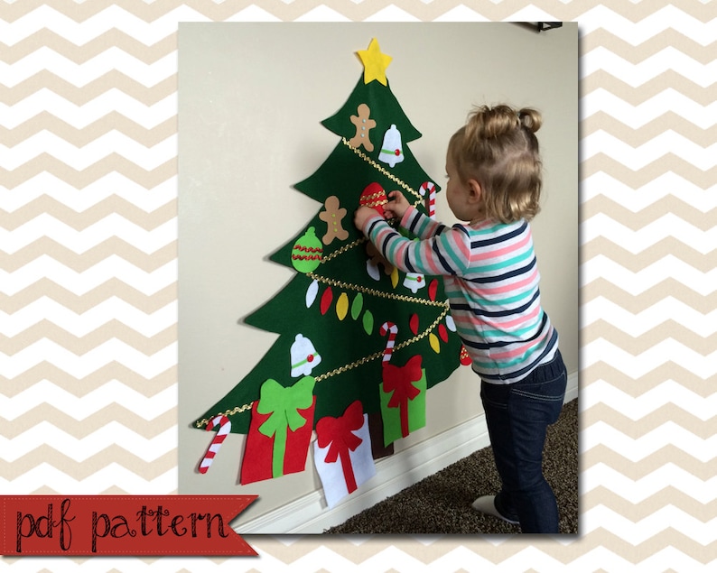 May include: A felt Christmas tree with a variety of felt ornaments, including stars, bells, candy canes, and presents. A child is decorating the tree with a felt ornament.