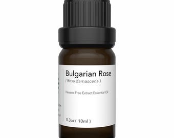 May include: A small, brown glass bottle of Bulgarian Rose essential oil. The bottle has a black cap and a white label with the text "Bulgarian Rose (Rosa damascena)" and "0.3oz (10ml)". The label also states "Hexane Free Extract Essential Oil".