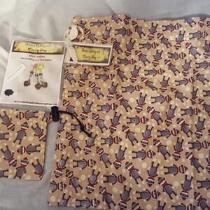 May include: Two drawstring bags with a monkey print design. The larger bag has a white tag that says "Sewing Quality and Sewing Shop". The smaller bag has a tag that says "Witch Cookies for Crafting and Decorations".