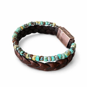 Braided brown leather bracelet with turquoise and brown beads. The bracelet features a magnetic clasp. The beads are a mix of blue, green, and brown. The leather is a dark brown color.