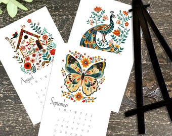 Folk Art 2026 Calendar with Light Glitter Accents. Available With or Without Black Display Easel 7&quot; x 4.5&quot; Desk or Wall Calendar