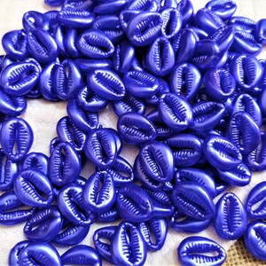 May include: A large pile of blue cowrie shells. The shells are smooth and shiny, and they have a slightly iridescent sheen.