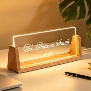 May include: A handmade, ceramic mug with a speckled, cream-coloured glaze. The mug has a wide, rounded body and a sturdy handle. The interior is a darker, earthy tone. The mug is approximately 10 cm tall.